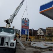 Mobile crane hanging a sign